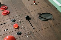 a close up of an electronic device with buttons and knobs on the board surface