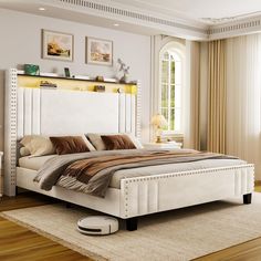 a white bed sitting on top of a hard wood floor next to a dresser and window