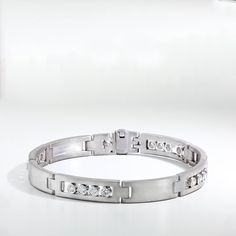 Men's bracelet made in 18K white gold with long smooth rectangular links that are satin finished. Every other station features four round bezel set sliding diamonds. 8" in length. Modern White Gold Bracelets Channel Set, Modern White Gold Bracelets With Channel Set, Modern Channel Set Diamond Bracelet For Anniversary, Modern Diamond Bracelet With Rectangular Links, Modern White Gold Diamond Bracelet Channel Set, Modern Channel Set Diamond Bracelet In White Gold, Modern Platinum Bracelets For Anniversary, Modern Platinum Bracelet For Anniversary, Modern Diamond Bracelet With Single Cut Diamonds