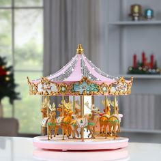 a merry go round carousel with horses on the front and sides, sitting on a table