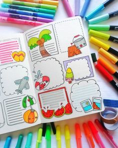 an open notebook with colorful markers and pens