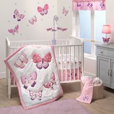 a baby crib with pink and purple butterflies on it