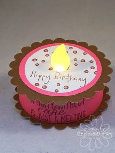 a pink and brown cupcake shaped birthday candle