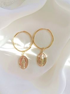 *22 karat gold plated hoop earrings for pierced ears *Charms: beautiful and very detailed Mother Mary medallions *Rings size: 20 mm *Ring thickness: 2  mm *Earrings length: 6 cm *Luxurious logo packing included Gold Dangle Huggie Earrings 14k Gold Filled, Gold Tarnish Resistant Huggie Earrings For Gift, Gold Tarnish Resistant Huggie Earrings As Gift, Gold Tarnish-resistant Huggie Earrings As A Gift, Nickel Free Gold-tone Hoop Jewelry, Nickel-free Gold-tone Hoop Jewelry, Gold 14k Gold-filled Hoop Earrings, Gold 14k Gold-filled Pierced Hoop Earrings, Pierced Gold Hoop Earrings 14k Gold Filled