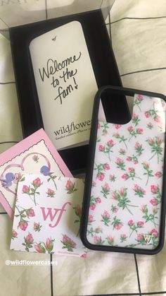 the phone case is decorated with pink flowers and has a welcome to the fan sticker