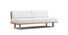 a white couch sitting on top of a wooden frame