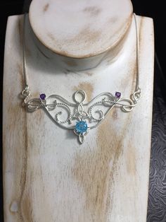 I love Victorian and Renaissance style statement necklaces with a magical and timeless flair, and I hope I've captured it within this piece! I shall fabricate for you this gorgeous Elvish/Renaissance style necklace, in sterling silver, with a center 8mm Blue Topaz and two side 4mm Amethyst gemstones. The center gemstone is 8mm round and the two sides are 4mm round. The chain will be soldered to each side and I will use a 1.2mm thick sterling box chain with a lobster claw clasp for added straight Magical Sterling Silver Pendant Jewelry, Mystical Sterling Silver Necklace In Silver, Magical Silver Pendant Necklace, Mystical Sterling Silver Necklace For Gift, Mystical Sterling Silver Necklace, Bohemian Sterling Silver Birthstone Jewelry, Spiritual Necklace With Sterling Silver Clasp As Gift, Artisan Birthstone Necklace For Gifts, Mystical Sterling Silver Pendant Necklace