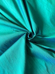 a close up view of a green fabric with blue lines on the top and bottom