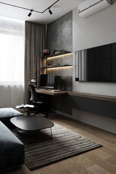 a modern living room with black furniture and wood flooring, along with a flat screen tv mounted on the wall