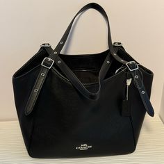 This Large Shoulder Bag Has Double Adjustable Straps And Measures 18”W X 10.5” D. There Is An Outside Zipper Pouch And A Top Zipper Closure. The Interior Has To Large Pouches On Either Side. Nwt Black Soft Leather Bag For Everyday Luxury, Everyday Luxury Black Soft Leather Bag, Black Satchel With Palladium Hardware For Everyday Luxury, Black Bags With Palladium Hardware For Everyday Luxury, Everyday Luxury Textured Leather Bag, Black Crossbody Shoulder Bag For Everyday Luxury, Black Luxury Tote Satchel For Everyday, Everyday Luxury Black Satchel Bag, Black Textured Leather Shoulder Bag For Everyday Luxury