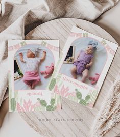 two cards with pictures of babies on them sitting on a table next to a blanket