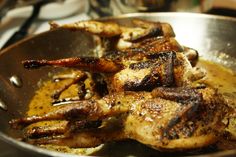 some chicken is cooking in a pan on the stove