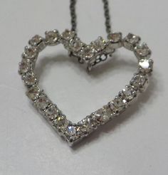 "Vintage silver tone heart pendant necklace. 1\" x 1\" heart is loaded with clear, faceted, and prong set rhinestones, all of which are present and intact. Very sparkly! Sterling chain is gorgeous! Unsigned." Silver Heart Pendant Rhinestone Necklace For Party, Vintage Heart Pendant Necklace For Party, Silver Heart Cut Necklace For Party, Heart-shaped Rhinestone Formal Jewelry, Silver Heart-shaped Rhinestone Necklace For Wedding, Silver Heart Rhinestone Necklace For Wedding, Silver Heart Shaped Rhinestone Necklace For Wedding, Heart Necklace With Rhinestones For Valentine's Day Anniversary, Valentine's Day Heart Necklace With Rhinestones For Anniversary