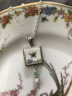 "Broken China Jewelry, Jewelry Theodore Haviland Limoges Butterfly Square Pendant Necklace Made from a Vintage Theodore Haviland Limoges China Plate, Circa 1940 Pendant Measures 3/4\" X 2\", including Pearl and Crystal Dangle Includes Antiqued Sterling Bail and 18\" Silverplated Chain This listing is for a hand-crafted, \"broken china\" necklace. This piece has been created by artistically repurposing a vintage Haviland Limoges china plate. What a perfect little piece of jewelry to liven up your Vintage Sterling Silver Jewelry With Square Pendant, Vintage Sterling Silver Square Pendant Jewelry, Vintage Silver Necklace With Square Pendant, Vintage White Nickel-free Jewelry, Vintage Nickel-free Square Pendant Jewelry, White Vintage Nickel-free Jewelry, Nickel Free Vintage White Jewelry, Vintage Square Pendant Jewelry, Vintage Square Pendant Jewelry For Anniversary