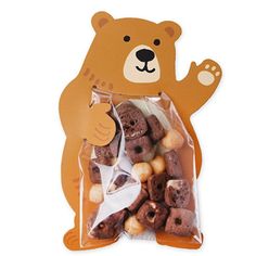 a bear shaped bag filled with donuts on top of a white table