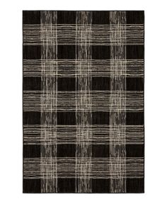 a black and white plaid rug on a white background with an area rug in the middle