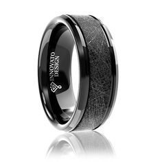 a black ceramic ring with an etched pattern inlaying the center and beveled edges