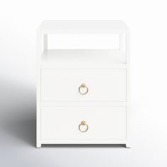 a white nightstand with two drawers and gold handles