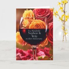 a wine glass with roses on it and the words, to a wonderful nephy & wife on their anniversary