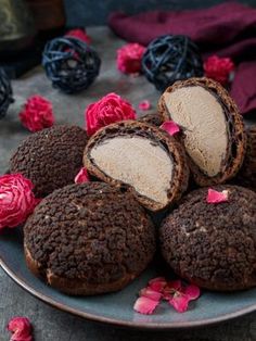 some chocolate cookies are on a plate with pink flowers