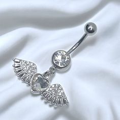 an angel belly ring with crystal stones on it