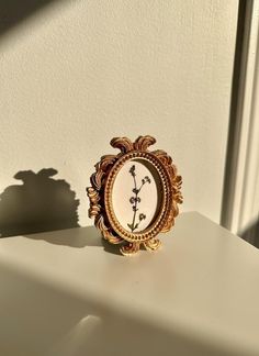 a small clock sitting on top of a white table