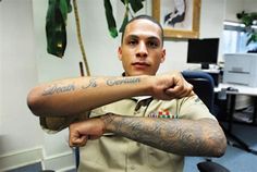 a man with tattoos on his arm in an office