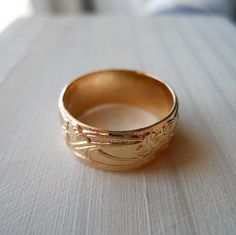 This band ring is handcrafted from 14k gold filled. It is a nice wide 8mm band. The pattern depth is shallow compared to some of my other designs. It adds a subtle interest without being over the top. If you want a more dramatic design I recommend my other heavy pattern ring that has a deep contrast to the pattern:https://www.etsy.com/listing/69736326/14k-gold-filled-heavy-pattern-band-ringThis ring makes a great wedding band. Couple with my 4mm pattern ring to make a wedding band set. http://ww Gold Etched Bands As Gift, Gold Etched Bands For Gifts, Gold Etched Band As Gift, Gold Etched Bands For Gift, 14k Gold Wide Band Ring Gift, Rose Gold Wide Band Ring As Gift, Engraved Wide Band Ring Stamped 14k, Wide Band Engraved Ring Stamped 14k For Gift, Engraved 14k Wide Band Ring As Gift