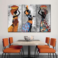 three african women with baskets on their heads are sitting in front of a dining room table