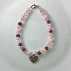 "🌸 Sign up for the Starfish by Kristan email list and get 15% off your order NOW! https://mailchi.mp/13833f6189a3/new-customers 🌸 Looking for high quality, affordable jewelry?  If so, this bracelet is for you!  This pink/clear 4mm round crystal bead bracelet with a silver heart charm. OUR BRACELETS ARE... *Made with high quality lava stones, semi-precious beads, silver, and glass beads *Tarnish free silver wire & gold wire, 925 silver, 1mm stretch cord, waxed linen cord *Crafted in house *Available in size 7.5\" CARE INSTRUCTIONS *Remove before swimming or showering *Do not use harsh chemicals  *Roll bracelet over hand, do not over stretch SHIPPING INFORMATION *Once I receive your order, I will ship out to you in the timeframe below *Orders are shipped in a padded mailer to ensure a safe Affordable Customized Pink Charm Bracelet, Bohemian Bracelets With Heart Charm For Valentine's Day, Bohemian Heart Bracelets For Valentine's Day, Bohemian Bracelets With Heart Beads For Valentine's Day, Bohemian Heart Beads Bracelets For Valentine's Day, Bohemian Heart Beads Bracelet For Valentine's Day, Bohemian Heart Bracelet With Heart Charm As Gift, Bohemian Heart Bracelet With Charm As Gift, Bohemian Beaded Bracelets For Valentine's Day