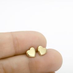 Shiny 14k solid yellow gold heart stud earrings by Sigal Gerson #goldstudearrings #heartstudearrings Sterling Silver Heart Earrings Tarnish Resistant For Everyday, Yellow Gold Heart Pendant Earrings For Anniversary, Gold Minimalist Heart Earrings For Everyday, Minimalist Valentine's Day Jewelry With Matching Earrings, Minimalist Jewelry With Matching Earrings For Valentine's Day, Yellow Gold Double Heart Earrings For Valentine's Day, Tarnish Resistant Yellow Gold Sterling Silver Heart Earrings, Minimalist 14k Gold Heart Earrings, Yellow Gold Heart Earrings For Her