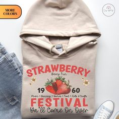 🍓🎨 Step into a world of vintage charm and festival vibes with our Vintage Watercolor Strawberry Festival Hoodie. This hoodie isn't just an article of clothing; it's a fusion of nostalgic art, festival spirit, and cozy comfort. 🎡 We have meticulously created a captivating vintage-style watercolor strawberry festival design. The result? A stunning blend of yesteryear's beauty and artistic flair, all adorning a comfortable and stylish hoodie. 🧥 Crafted from premium materials, this hoodie offers the perfect balance of softness and durability. The relaxed fit ensures both comfort and style, making it an ideal choice for laid-back outings, casual gatherings, or simply embracing the festive spirit. 🌼 The vintage watercolor strawberry festival artwork transports you to a time when celebration Vintage Long Sleeve Hoodie For Spring, Retro Cotton Hoodie For Spring, Vintage Letter Print Sweatshirt For Spring, Retro Hoodie With Letter Print For Fall, Fall Festival Casual Hoodie, Vintage Hooded Hoodie For Spring, Casual Fall Festival Hoodie, Vintage Hoodie For Spring Streetwear, Retro Hooded Sweatshirt For Fall