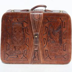 "Vintage Luggage Suitcase Travel Bag Mexican Hand Tool Leather & Tag Mayan Aztec Designs Artmex Large Photo Prop Mid Century Modern.  Wowzer  This piece may have been a souvenir from a Mexican holiday!  It is utterly amazing  Genuine leather!  The entire bag is covered with hand tooled Mayan or Aztec designs/details.  I apologize if my references to Mayan & Aztecs are incorrect or may non-intentionally offend anyone.  Goldtone hardware.  No key.  This suitcase measures approximately 23 1/2 x 18\" (20\" including handle) x 7\".  It weighs 6 lbs. Inside one side features a light tan satin like material pouch and the other side has same material on bottom but quilted.  This same material has been fashioned into hinges.  Brown grosgrain ribbon is used for ties to hold clothing in place.  Very Rectangular Travel Bag With Leather Lining, Brown Leather-backed Rectangular Luggage, Brown Rectangular Luggage With Leather Backing, Rectangular Briefcase For Trips, Vintage Rectangular Travel Bag With Leather Backing, Bohemian Leather Rectangular Travel Bag, Bohemian Leather Travel Bag, Rectangular Brown Cases For Trip, Brown Rectangular Cases For Trip