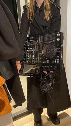 a woman holding a dj controller in her hands