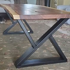 a wooden table sitting on top of a carpeted floor