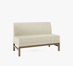 a white couch sitting on top of a wooden frame