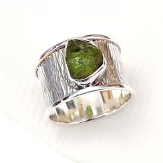 925 Sterling silver Texture band Ring, Peridot Handmade Ring, Raw Peridot gemstone Ring, Unique handmade Raw gemstone Rings.Product:- RingModal no:- U124Metal:- 925 Sterling SilverGemstone :- PeridotGemstone size:- 9x11Finishing:- Shiny SilverWe are using Pure 925 (Stamped) Sterling Silver with Natural Gemstone Jewelry, all of our jewelry designs are Handmade.We are adding new creative designs in our store regularly, for new handmade stuff please get touch with our store.We always try to provide Silver Tourmaline Ring For Anniversary, Silver Peridot Rings With Polished Finish, Silver Tourmaline Ring With Polished Finish, Bark Ring, Silver Texture, Raw Peridot, Raw Gemstone Ring, Peridot Crystal, Raw Stone Ring