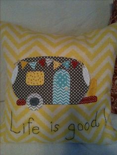 a pillow that says life is good with an animal on it and the words'life is good'written in cursive font