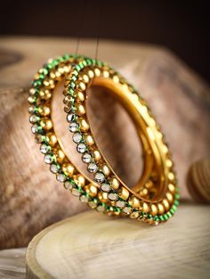 Silver Gold Plated Bangle colour Available Yellow Gold ,White Gold ,Rose Gold plating bangles 2 Bangle Set Gemstone Kundan Bangle size available 2-4,2-6,2-8. Happiness looks gorgeous on you, and you must wear it all the time. One way to do it is with the Green Kundan Gold Plated Set of 2 Bangle Set. Crated in the traditional style, these bangles are gold-plated and have the classic design of kundan studded circles placed one after another to embrace your wrists with elegance. With its green outl Hand Set Bangle For Festivals, Adjustable Jeweled Bangle Jewelry, Plated Bangle Jewelry, Plated Bangle Bracelets - Perfect Gift, Silver Beaded Bangle Bracelets For Festivals, Bangle Bracelets With Plating As A Gift, Festive Hand Set Bracelet, Festive Round Fusion Bracelets, Gift Bangle Bracelets With Plating