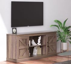 a flat screen tv mounted to the side of a wooden entertainment center next to a potted plant