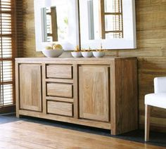 a large wooden cabinet with two mirrors above it