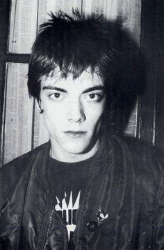 an old photo of a young man wearing a leather jacket