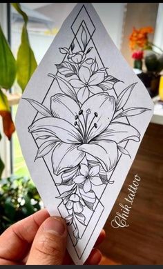 a hand holding up a card with flowers on the front and back side in black ink