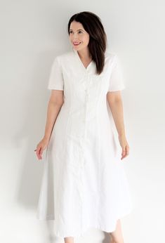 🤍 VINTAGE LAURA ASHLEY WHITE LINEN LINED MIDI BUTTON DOWN DRESS WITH EMBROIDERED DETAIL 🤍 Perfect for summer days and holidays, this stunning 90s dress is cool and super stylish. Made from linen and cotton, this dress is elegantly beautiful. It features buttons down the front and stunning floral white embroidery details on the chest and sleeves. The dress is finished with beautiful scalloped edges, adding a touch of sophistication. Ready to make memories this summer, just team it with sandals Classic White Vintage Dress With Short Sleeves, Classic White Button-up Dress, Classic White Dress With Placket, White Vintage Dress With Buttons For Spring, A-line Vintage Dress With Buttons For Daywear, Vintage Dress With Button Closure For Daywear, Vintage White Buttoned Dress, Classic Vintage Dress With Button Closure For Daywear, White Vintage Dress With Buttons