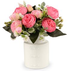 a white vase filled with pink flowers and greenery