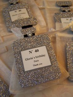 silver glitter birthday favors with name tags on them