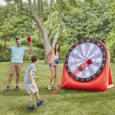 a family playing with an inflatable dart and ball game