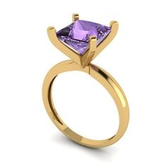 a yellow gold ring with a purple stone in the center and an arrow shaped band