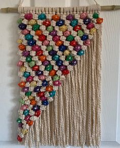 a wall hanging made out of macrame beads