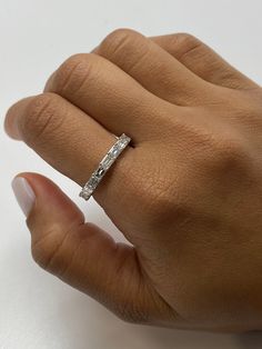 a woman's hand with a diamond ring on it